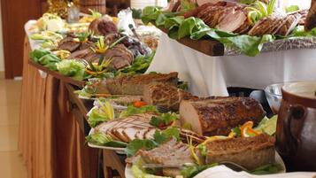 Una mesa de buffet con diferentes carnes y ensaladas.