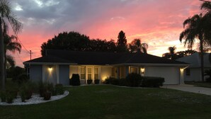 A single-story house with a front porch, a garage, and a well-maintained lawn.