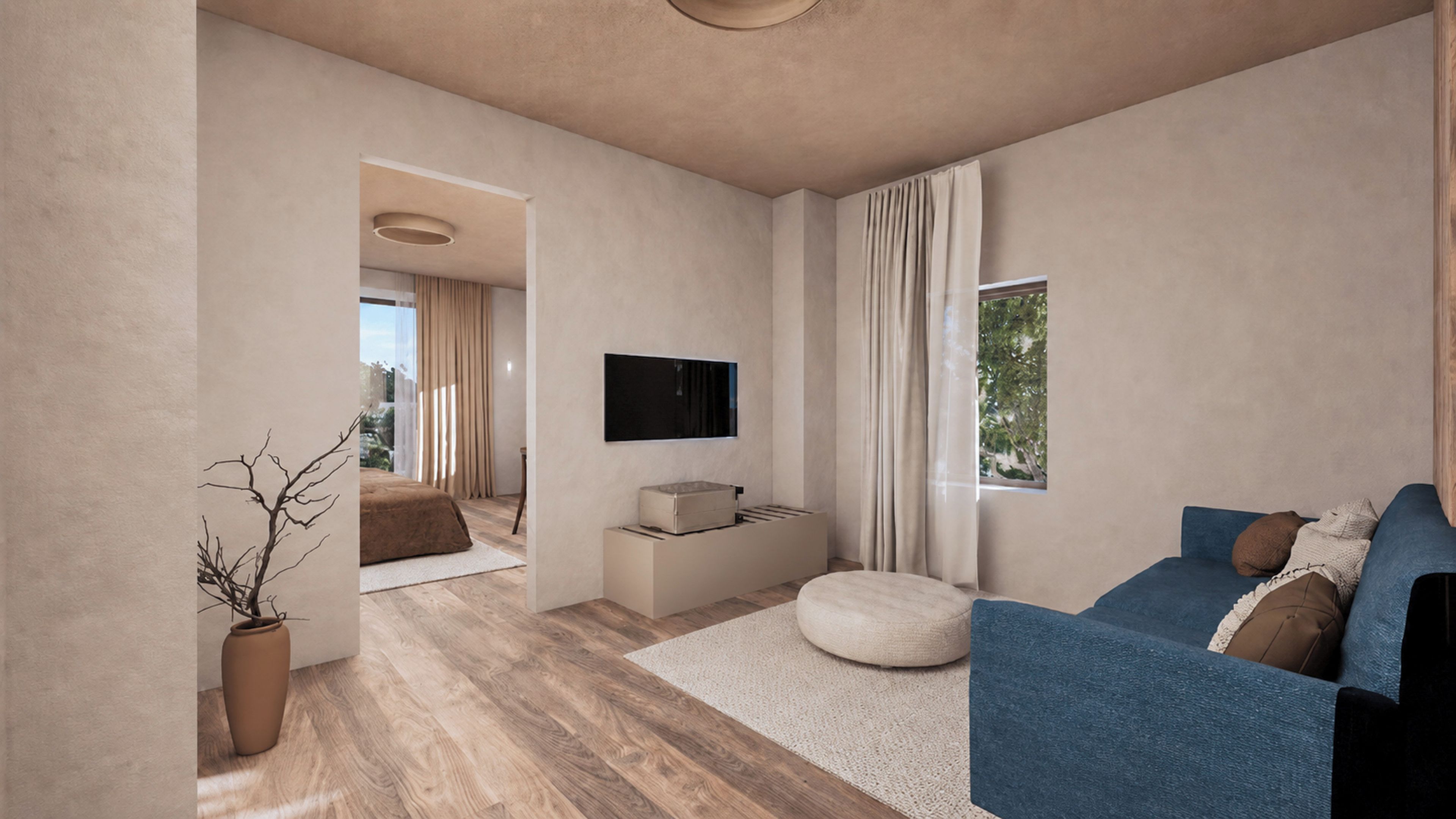 A modern living room with a blue sofa, a flat-screen TV, and a wooden floor.