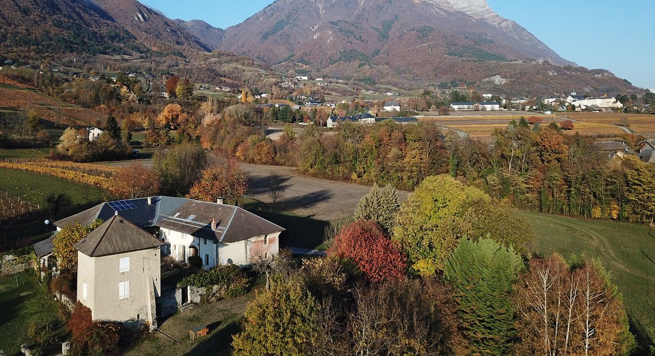 A mountainous landscape with a village, houses, and vineyards.