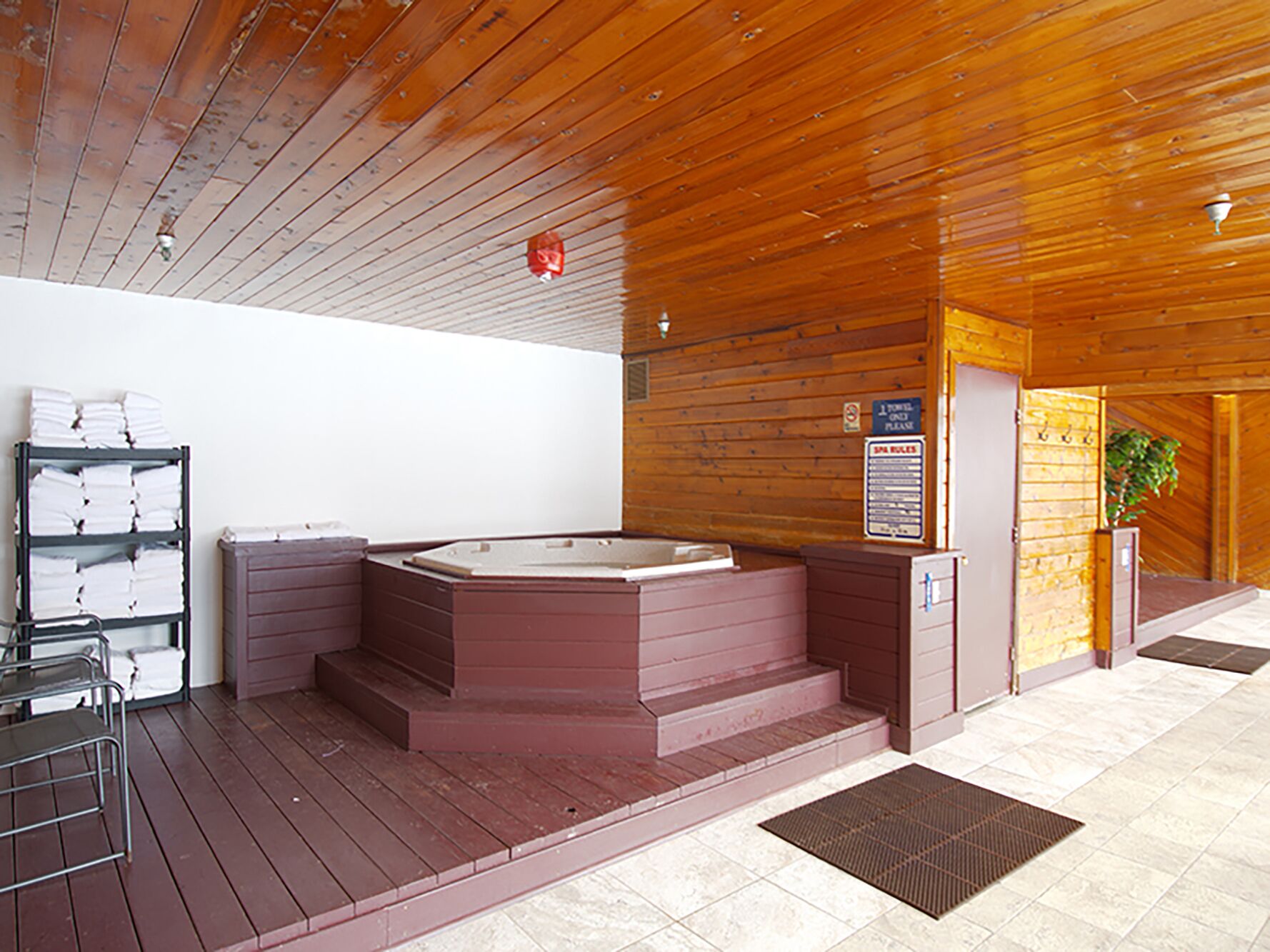 Unwind in the common area hot tub sanctuary, where warm wood surrounds and fluffy towels await your perfect relaxation moment.
