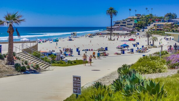 A beach with a staircase leading down to the shore, a lifeguard tower, and a sign indicating no dogs allowed. - The Perfect large Family Beach Getaway! 3 Min Walk To Beach - Family reunions! (Encinitas)