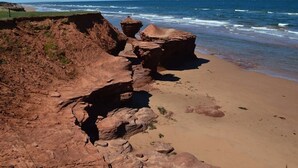 A coastal landscape with rocky formations and a sandy beach. - Rest Ashored in Anne's land!- Hot tub, Kayaks Centrally located, stunning views. (Kensington)
