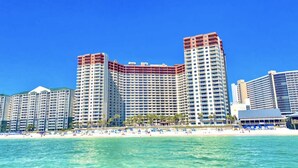 A beachfront hotel with multiple high-rise buildings, a sandy beach, and clear blue skies. - Shores of Panama 2BR Unit 1911! 19th Floor Gulf Views! Luxury Furnishings! (Panama City Beach)