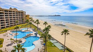 A resort with a large pool area, a beach, and a hotel building. - Sonoran Spa W603 - 2 BR Next to the Pool, High Speed Wi-Fi - Beachfront Upper Floor Luxury Condo (Puerto Peñasco)