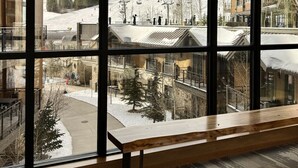 A modern interior with large windows offering a view of a ski resort. - Luxury Ski-in/Ski-out residence (Breckenridge)