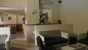 A lobby with a bar area, seating, and a check-in counter. - Hotel Romeo (Torri del Benaco)
