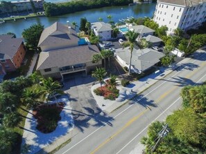 An aerial view of a residential area with houses, a swimming pool, and a river. - Siesta Key Waterfront Condo, Fishing Pier, Pool - Short Walk to Turtle Beach! Cozy Cove 3 (Siesta Key)