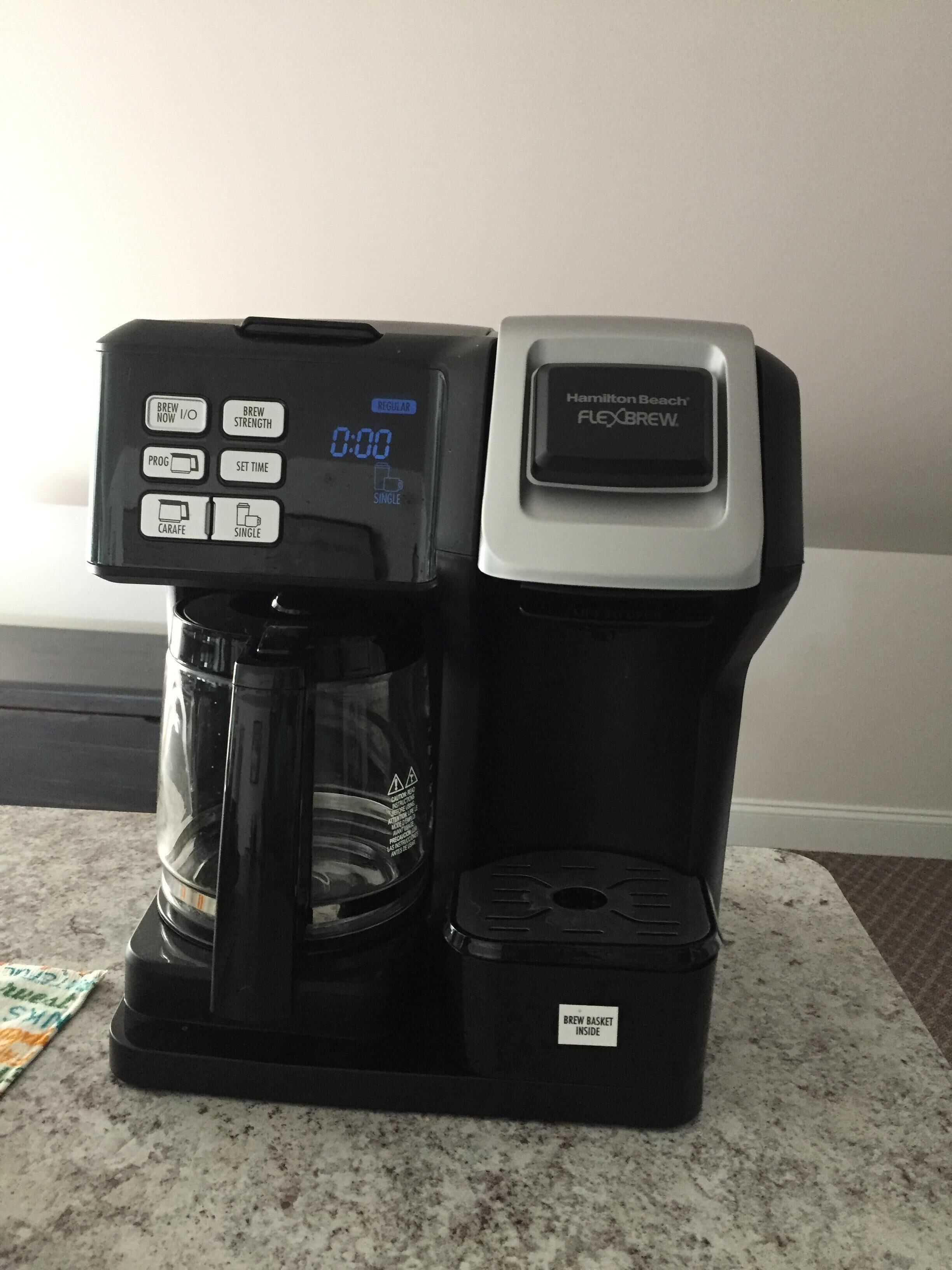 Eine Hamilton Beach Flexbrew Kaffeemaschine mit digitaler Anzeige, einer Kaffeekanne und einem Brühkorb.