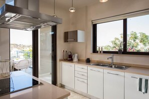 Enjoy cooking in this well-equipped kitchen with an oven, stainless steel sink, and ample natural light.