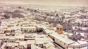 A snow-covered town with a prominent building featuring a tower.