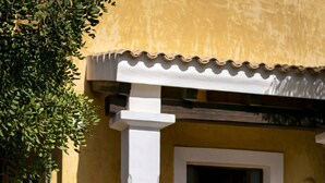 A yellow building with a white door and a mailbox. - CAN NOVES - Detached, central and peaceful villa (Sant Francesc de Formentera)
