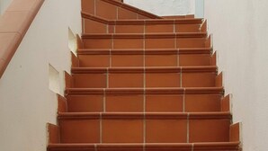 A staircase with terracotta steps and white walls. - House with terrace, five minutes from Sottotorre beach (Calasetta)