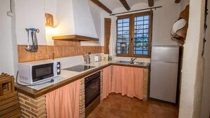 A compact kitchen with a microwave, sink, and oven.