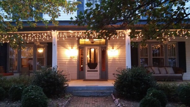 A house with a porch, a front door, and a bench. - 7 Bedroom Manor near Appomattox & Lynchburg (Concord)