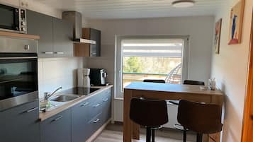 Fridge, stovetop, dishwasher, coffee/tea maker
