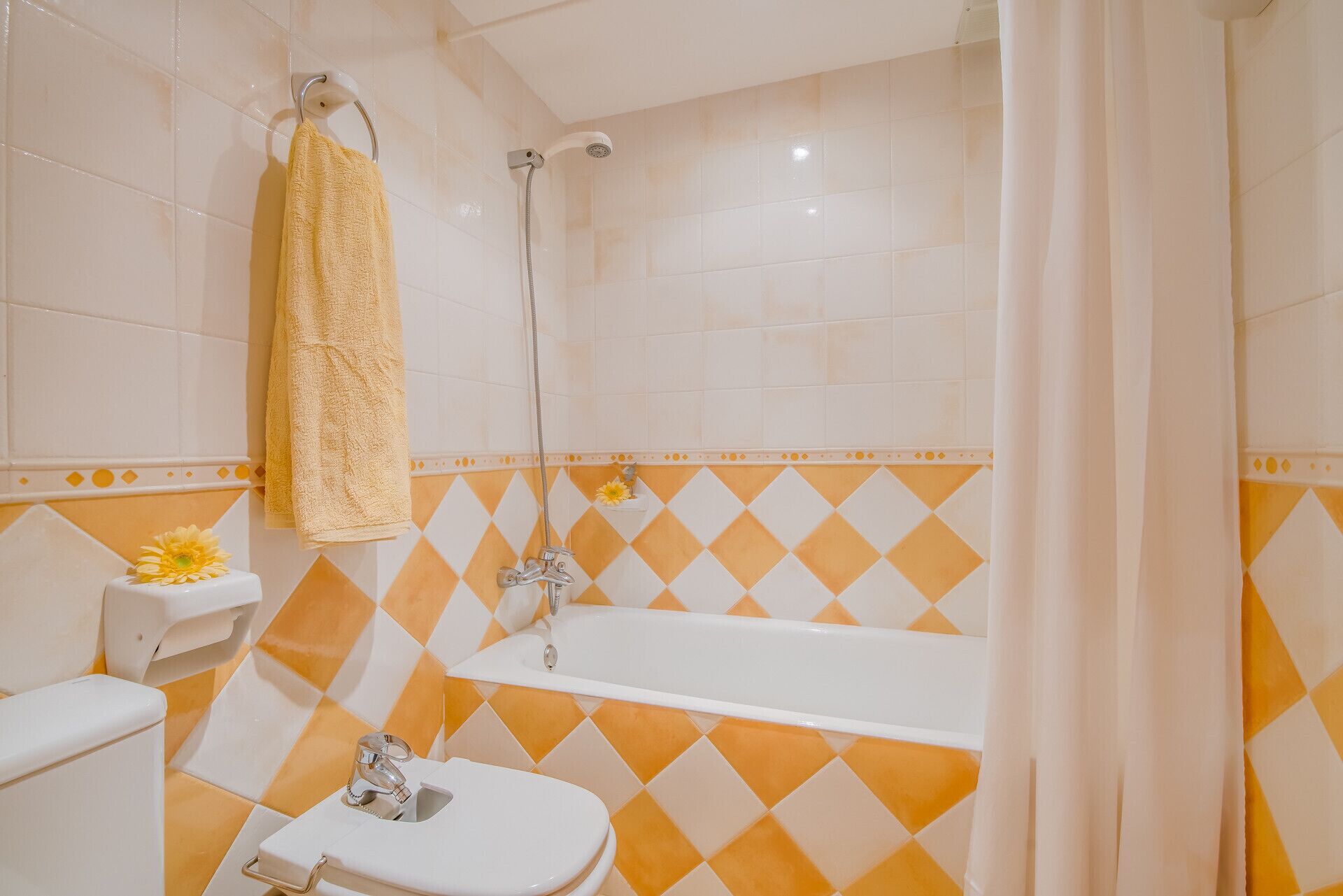 A bathroom with a bathtub, a toilet, and a shower.