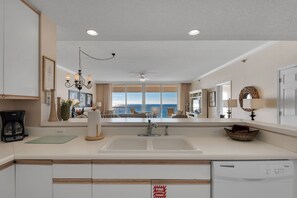 Enjoy ocean views from the kitchen window, where a central island and dishwasher make meal prep a breeze.