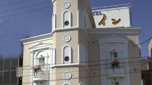A building with a prominent 'HOTEL' sign, classical architectural style, and decorative elements like flower baskets. - Fine Sakai (Sakai)