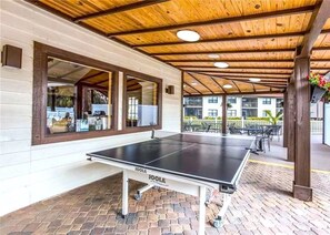 An outdoor ping pong table with a wooden ceiling and brick flooring. - Beautiful 2 Bedroom 2 Bath Fully Furnished Condo Close To Beaches & IMG (Bradenton)