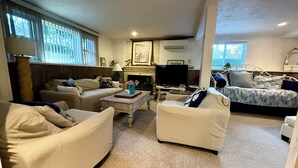 A cozy living room with a fireplace, a television, and comfortable seating. - Waterfront Plymouth Pond Retreat, Sleeps 6, Pet-Friendly, Kayaks, Fire Pits (Plymouth)