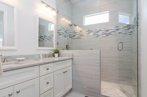 Bathtub, hair dryer, towels, toilet paper