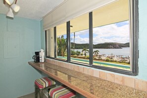 Enjoy a view of the pool and surrounding landscape from the large window in this room.