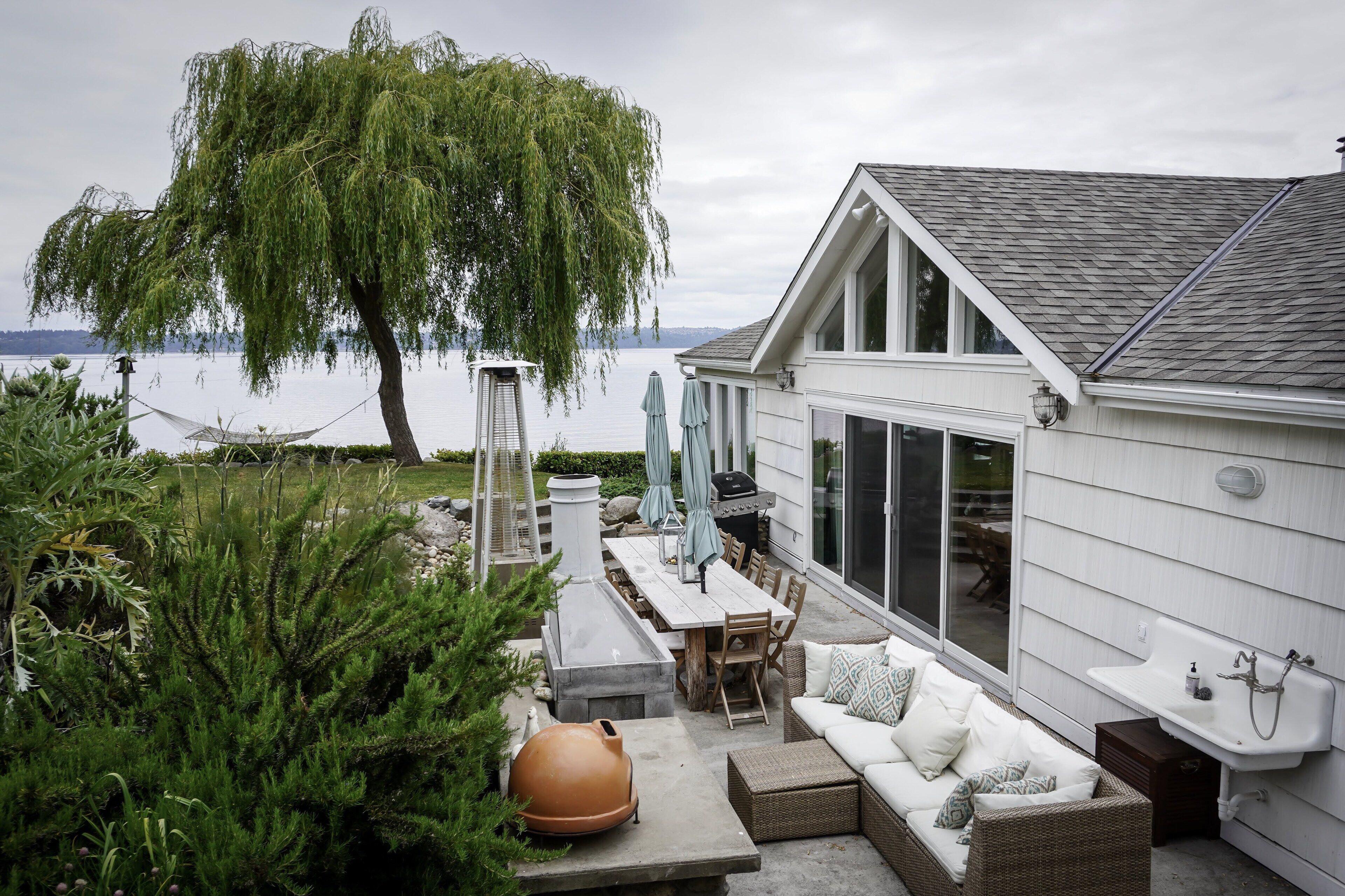 The East Patio (gas bbq, outdoor fireplace with grills, sink.  Made for relaxing