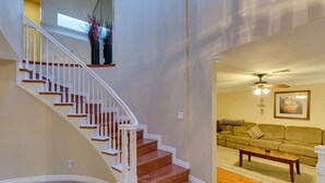A staircase with white balusters and wooden steps leading to a second floor. - Family Fun, Pickleball, Pool/Spa, Water slide (Las Vegas)