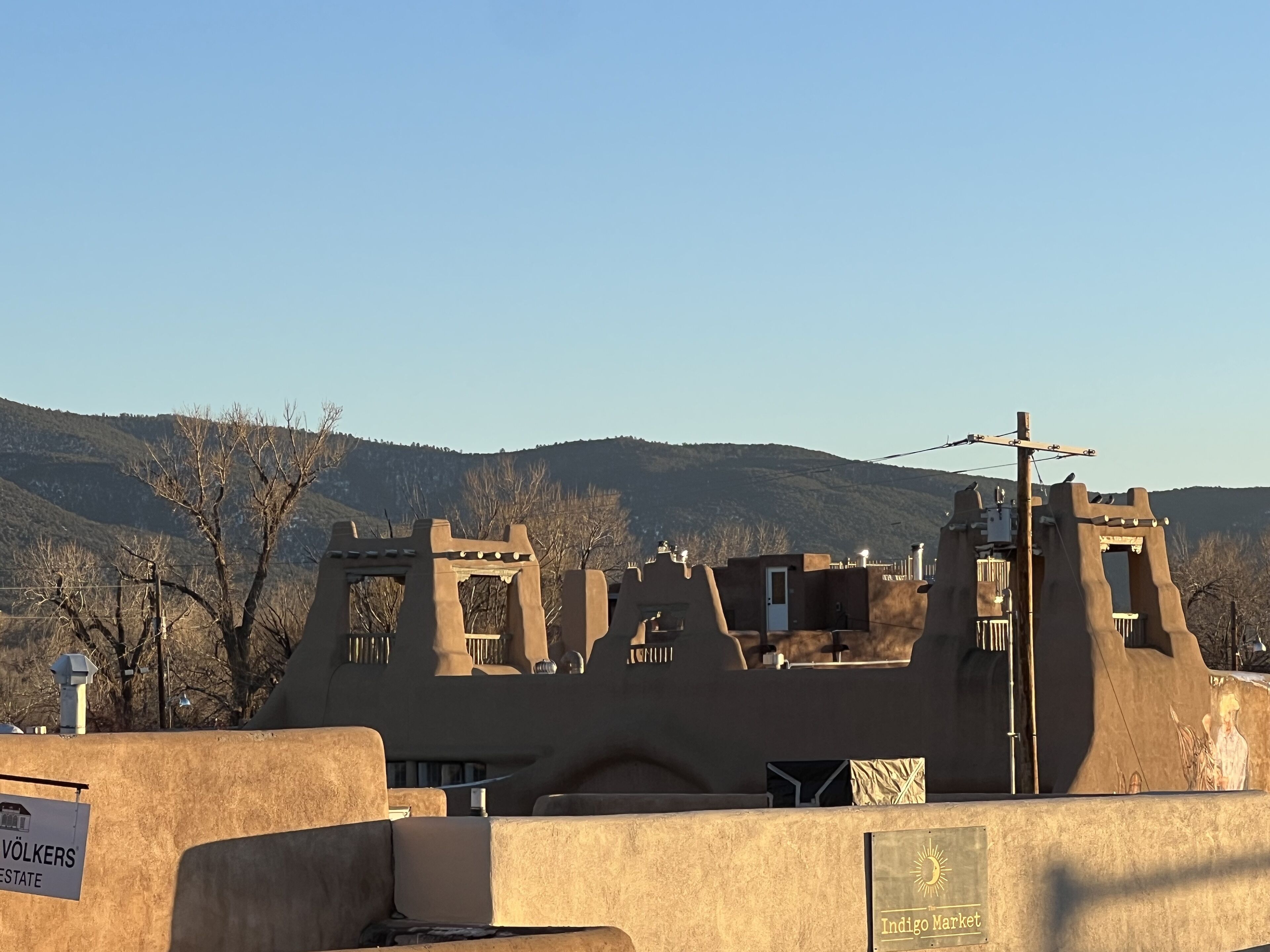 A building with a unique architectural style, featuring multiple towers and a flat roof.