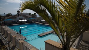 A swimming pool with multiple lanes, surrounded by buildings and palm trees. - 25% DisCount;  Rarely Available, OCean View & Sunsets; Steps to Sand (Laguna Beach)