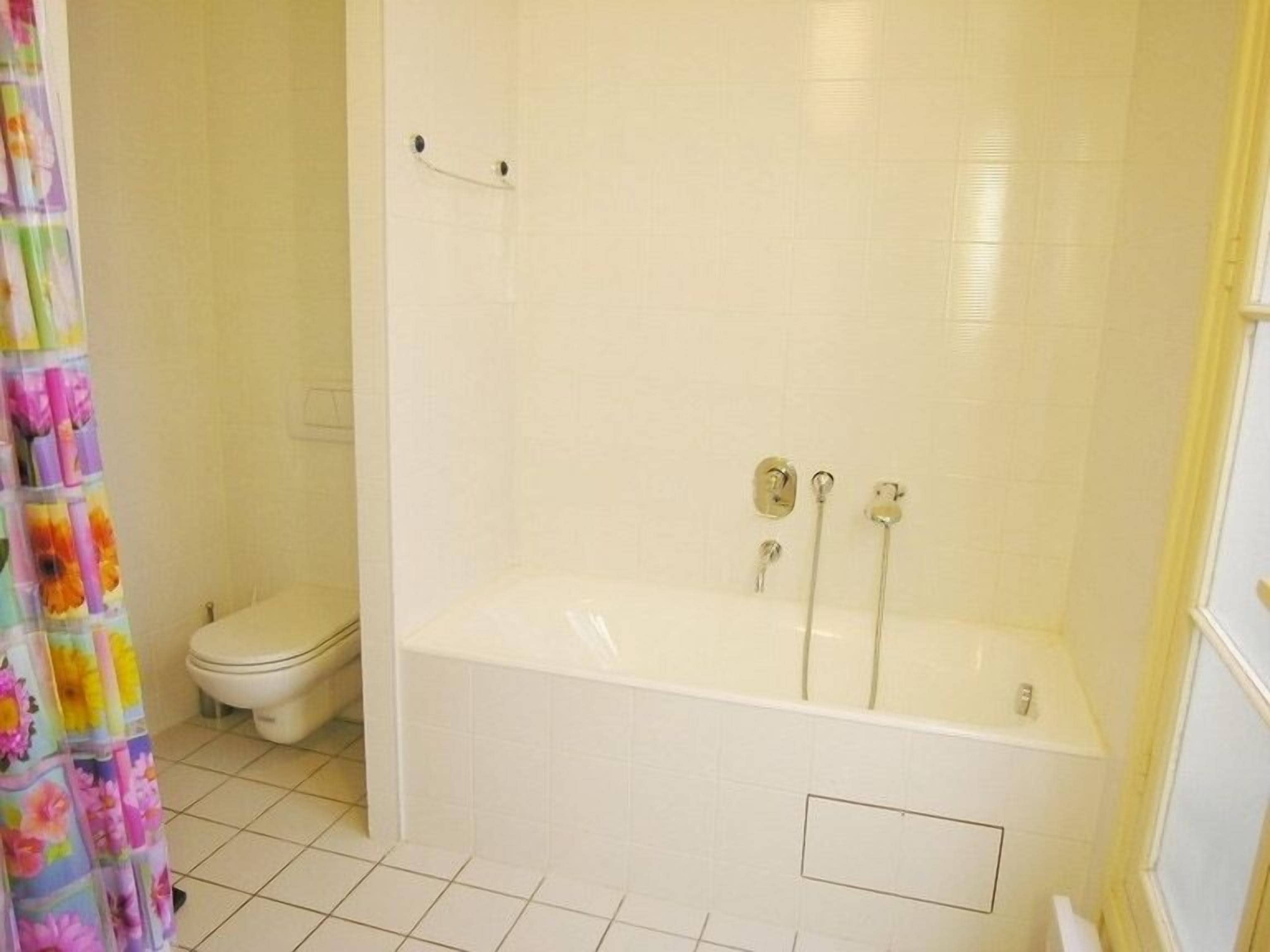 Separate bathtub and shower, hair dryer, towels