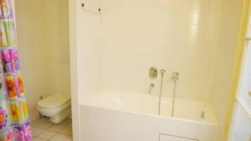 Separate bathtub and shower, hair dryer, towels