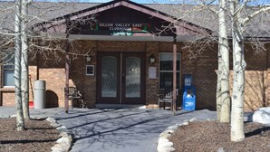 A brick building with a sign reading "Dillon Valley East Clubhouse." - 2 Bed 2 Bath Family Ski Condo (Pet Friendly!) (Dillon)