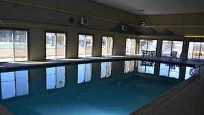 An indoor swimming pool with clear windows, a lifeguard chair, and a view of the outside. - 2 Bed 2 Bath Family Ski Condo (Pet Friendly!) (Dillon)