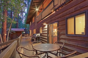 A wooden cabin with a balcony, outdoor seating, and a grill. - Kobey's Ski Lodge - Sleeps 33 - Theater Room - Game Room - Golf - Dogs Welcome (Pinetop)