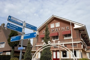 A hotel with a sign indicating directions to nearby locations.