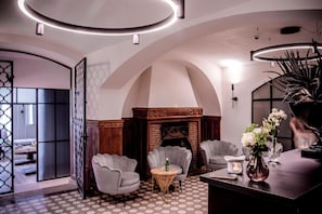 A modern interior with arched ceilings, a fireplace, and seating area.