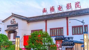 A traditional building with a sign that reads 'Shangri-La Hotel' and a traditional Chinese architectural style.