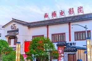 A traditional building with a sign that reads 'Shangri-La Hotel' and a traditional Chinese architectural style.