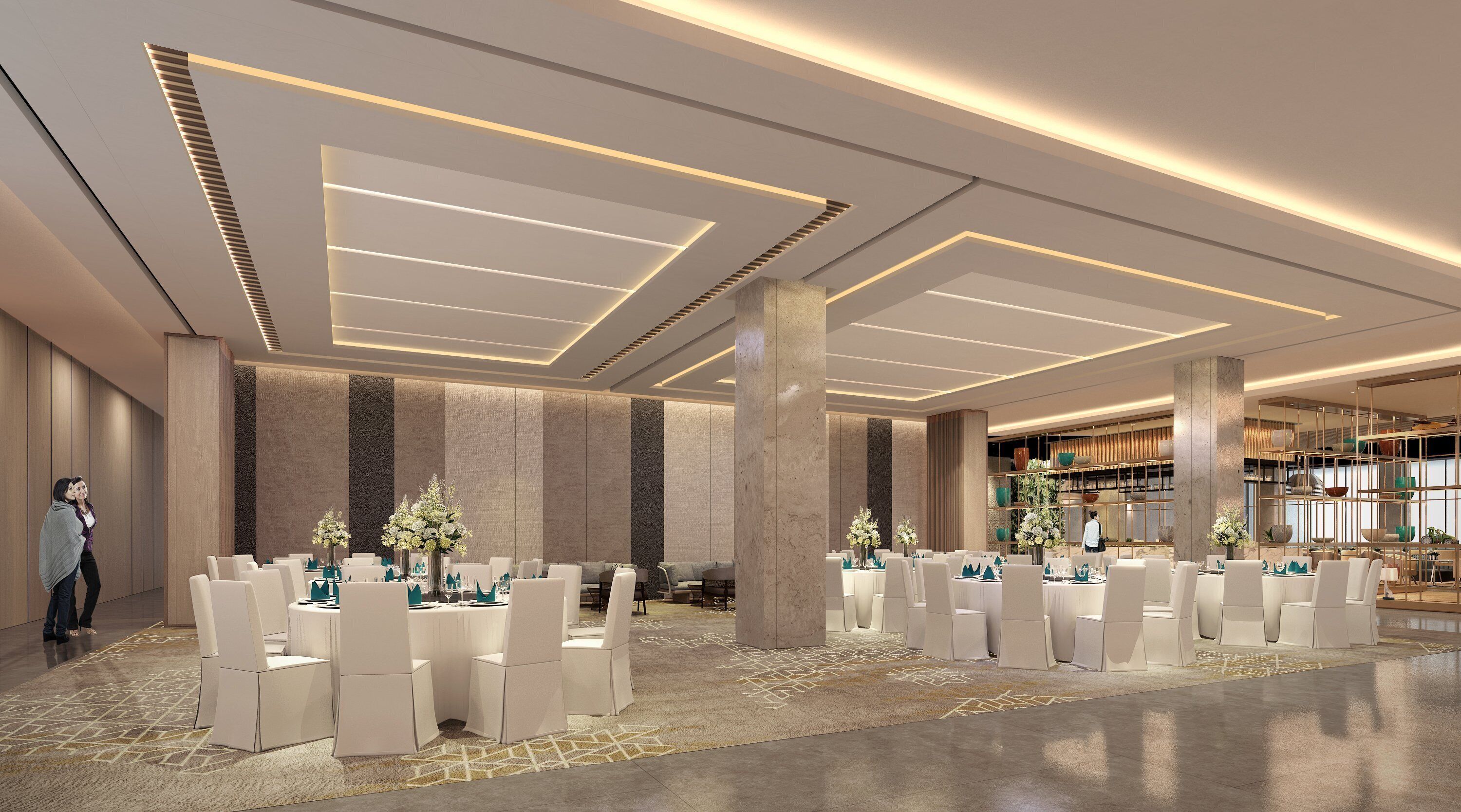 A spacious hotel lobby with high ceilings, modern lighting, and a central seating area with round tables and chairs.