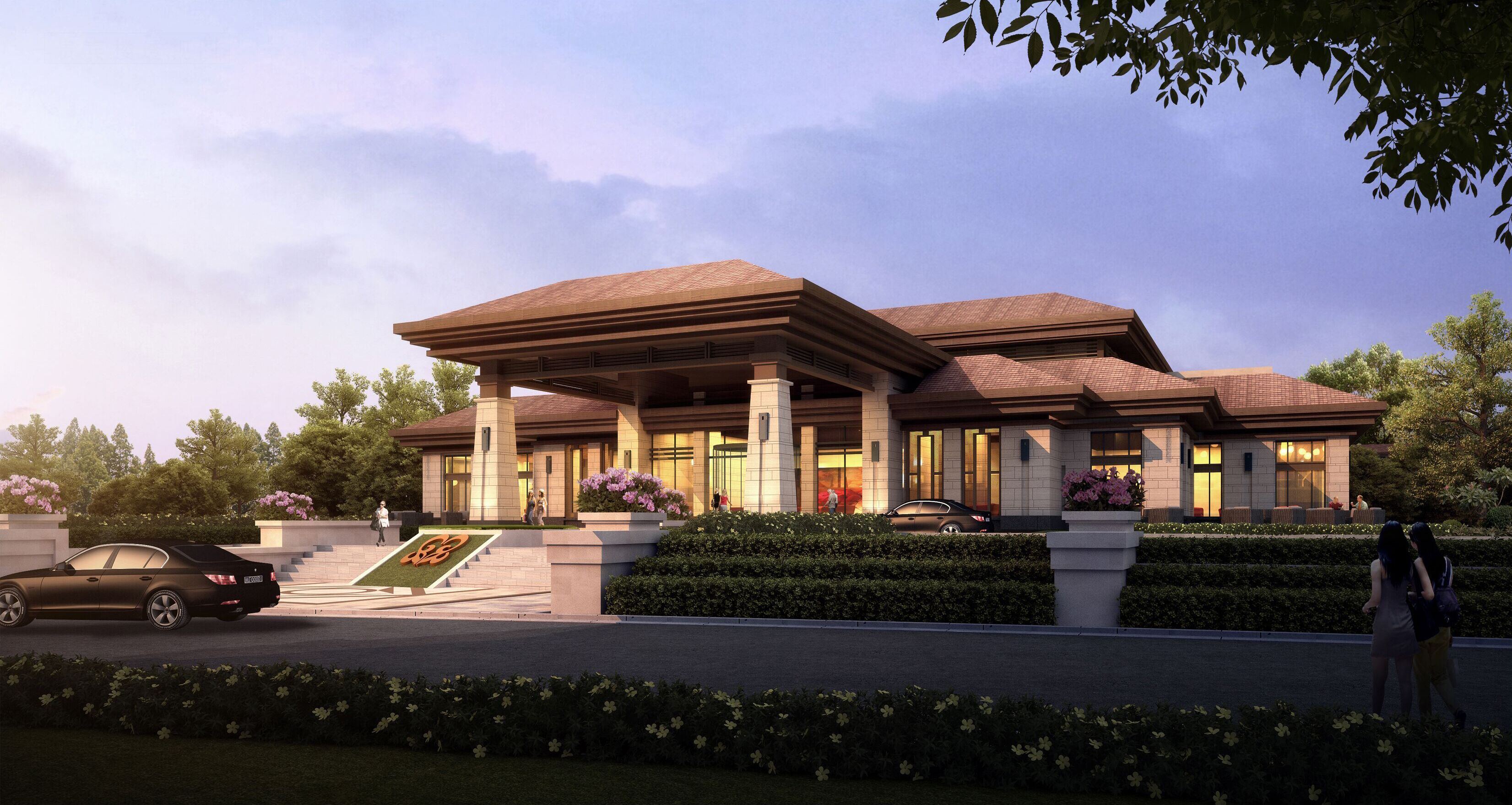 A modern building with a large entrance, columns, and a landscaped garden.