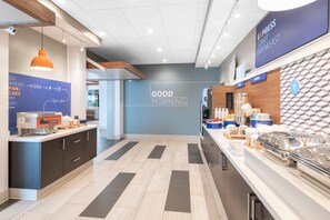 A modern breakfast area with a sign reading "EXPRESS START BREAKFAST" and a "GOOD MORNING" sign on the wall. - Holiday Inn Express & Suites Phoenix - Airport North by IHG (Phoenix)