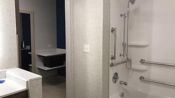 A modern bathroom with a shower, toilet, and sink.