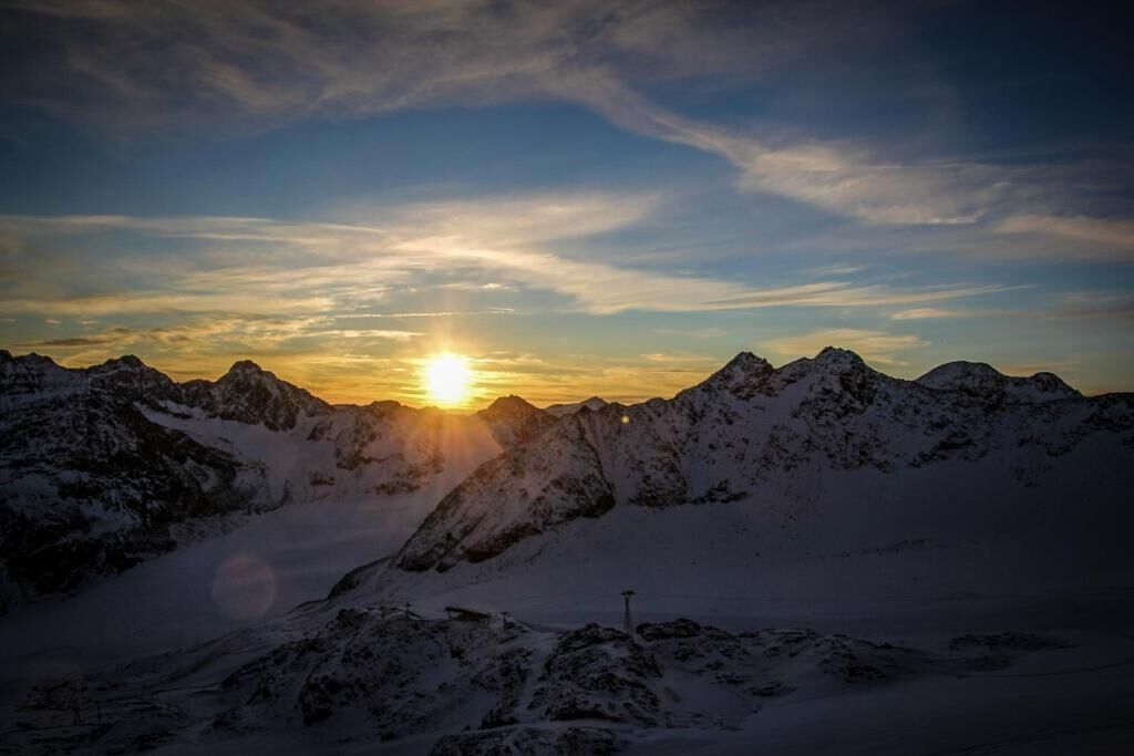 A mountainous landscape with a sunset.