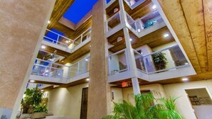 A multi-story building with balconies and a wooden facade. - 3rd fl. Bayfront condo, balcony, parking, bikes (San Diego)