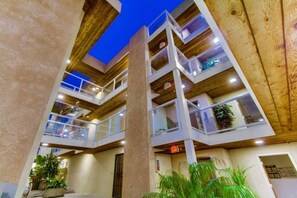 A multi-level building with balconies, wooden beams, and potted plants. - 3rd fl. Bayfront condo, balcony, parking, bikes (San Diego)