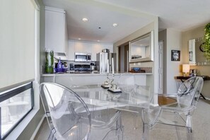 A modern kitchen with white cabinets, a microwave, and a coffee machine. - 3rd fl. Bayfront condo, balcony, parking, bikes (San Diego)