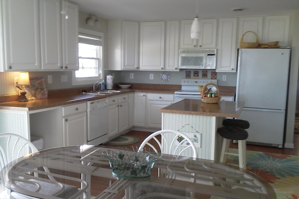 Great kitchen with views of the river and easy access to outside grill