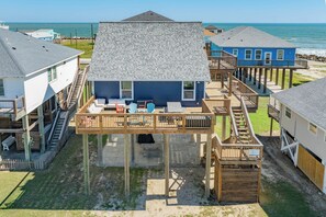 A beachfront property with multiple levels, including a main house and several smaller structures. - Across the Pass - Pick Your Sunrise or Sunset Sea! (Freeport)